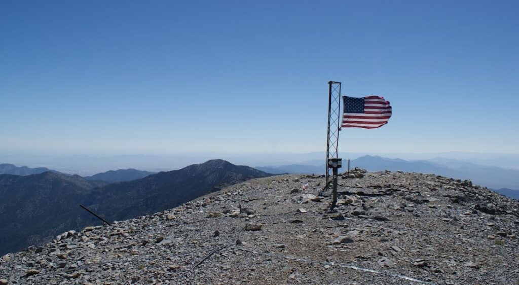 Flag on top of a mountain