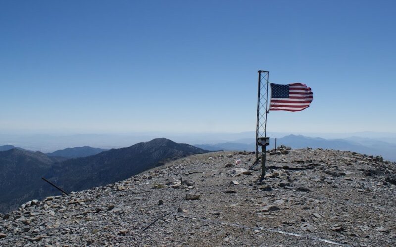 Flag on top of a mountain